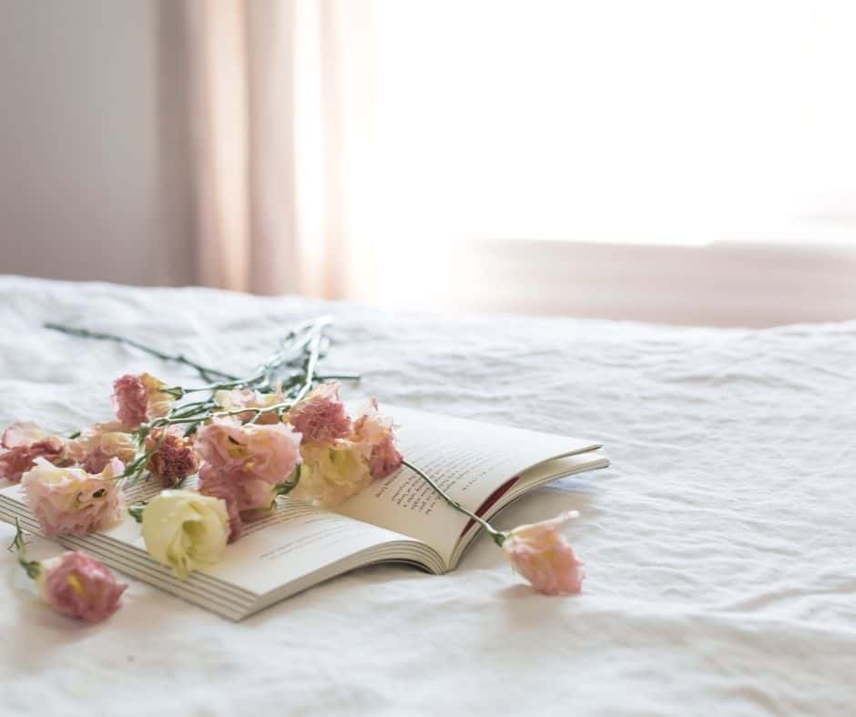 flowers and book on a bed
