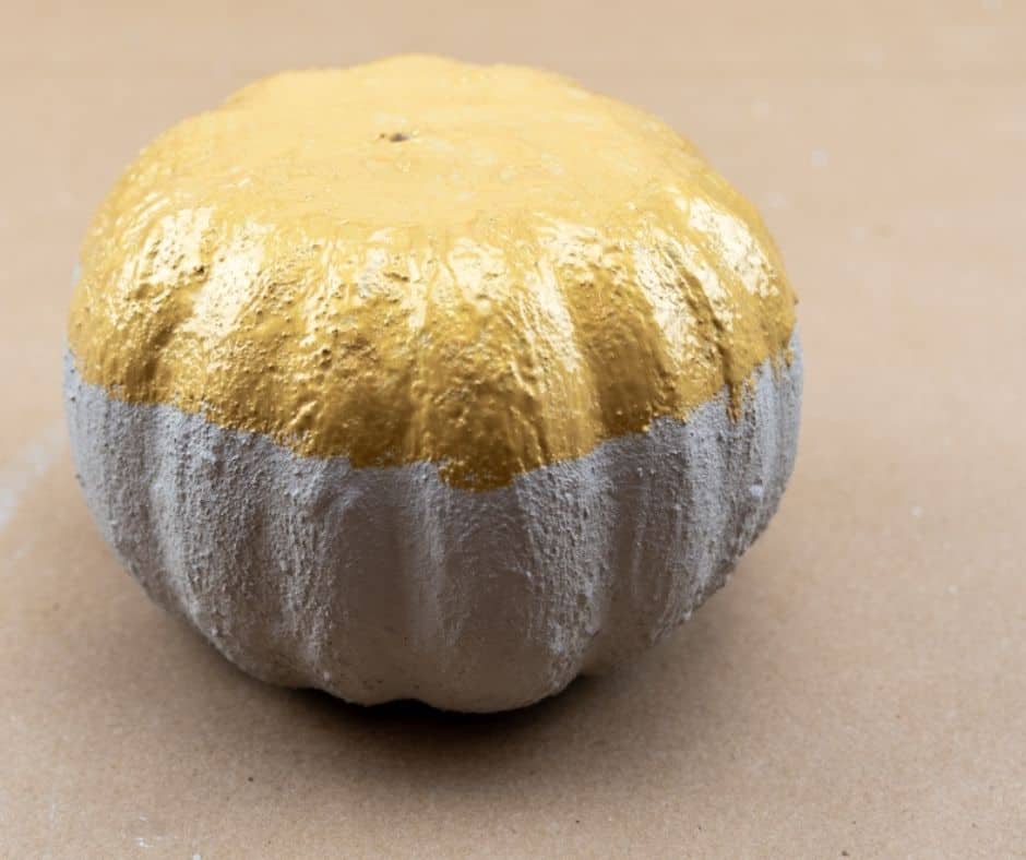 gold and concrete pumpkin drying