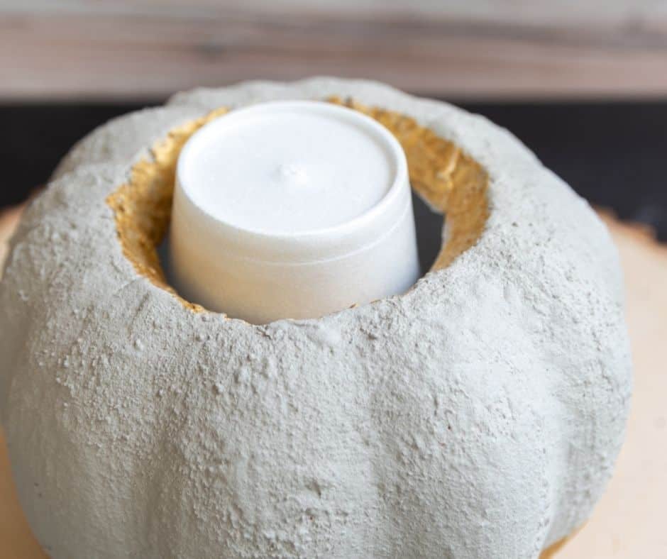 concrete pumpkin with styrofoam cup inserted upside down