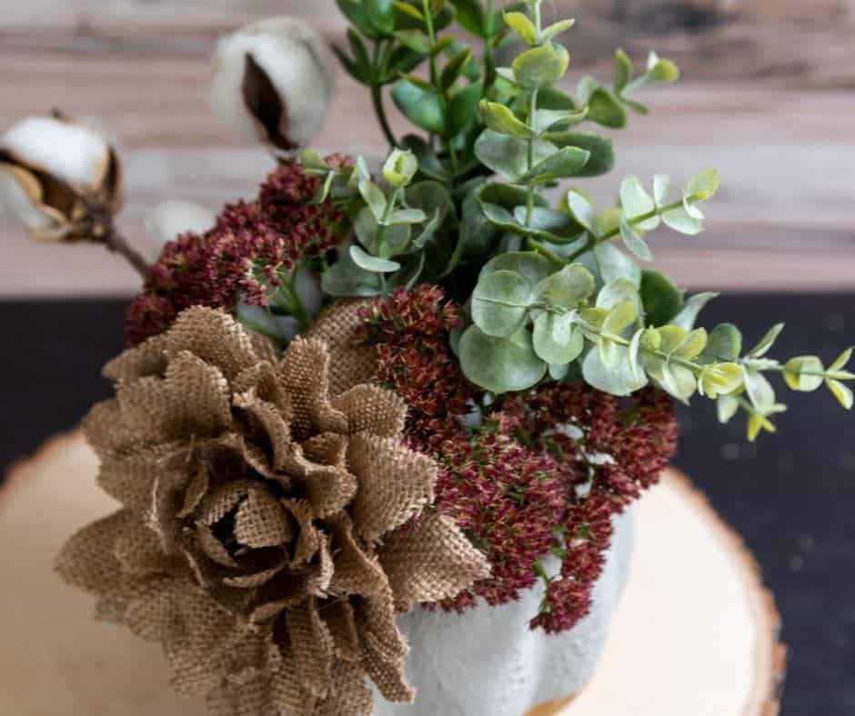 top view of gold and concrete pumpkin with flowers