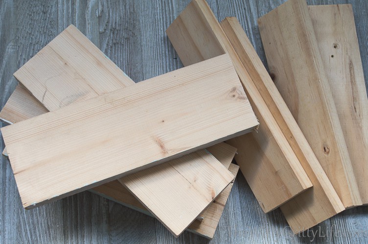 a pile of scrap wood boards about to be turned into lamp columns