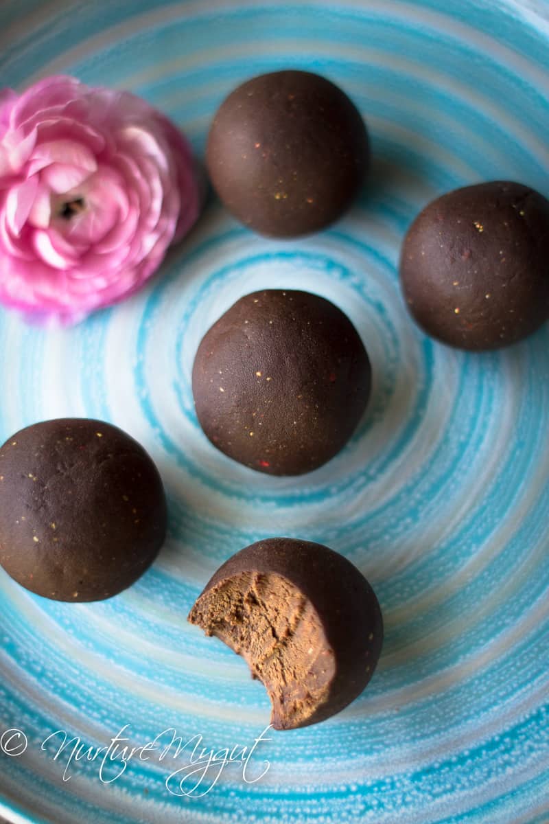 Picture of round chocolate covered balls, one with a bite missing