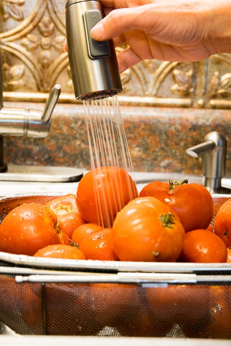 Picture of tomatoes being rinsed with water