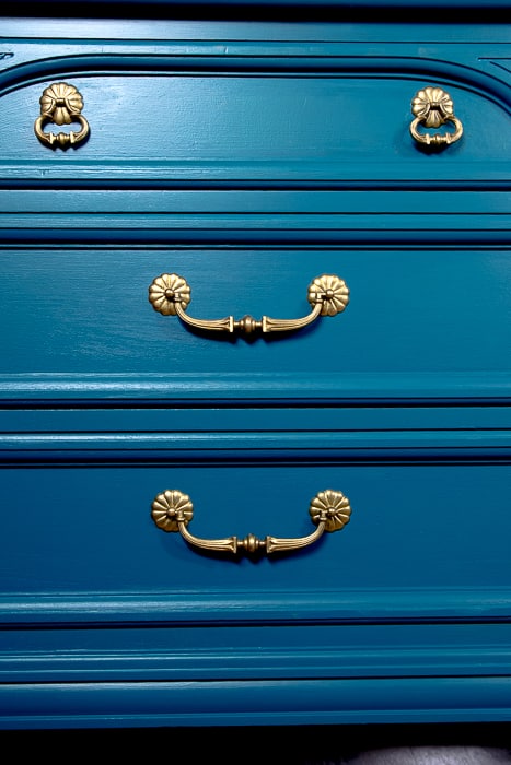 picture of teal drawers with gold hardware