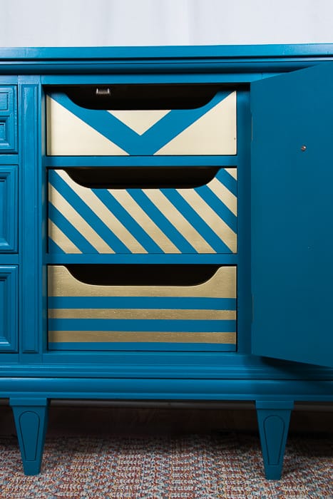 Picture of gold and teal colored interior drawers of a teal dresser