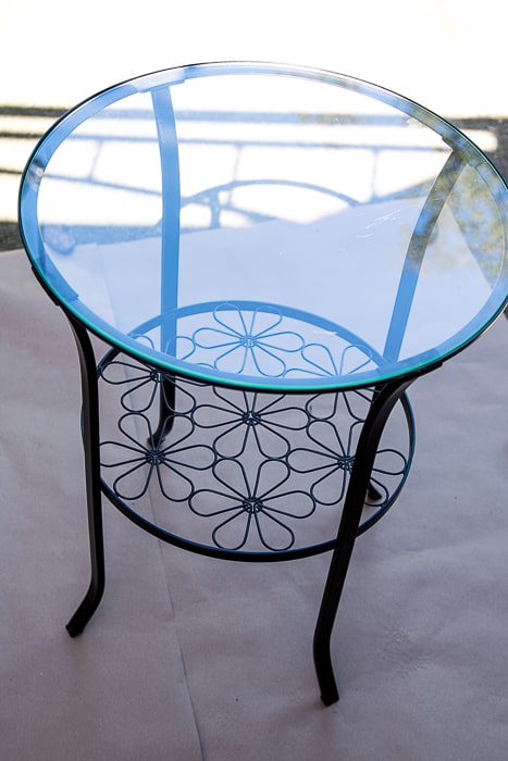 Picture of round black metal table with flowers and glass top