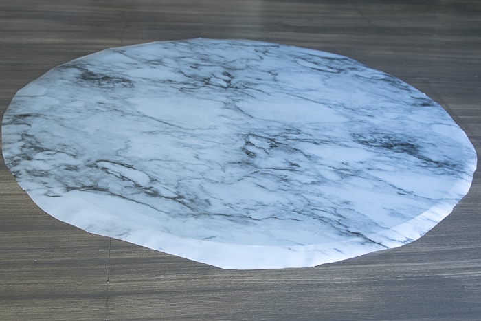 picture of round glass with marble adhesive shelf liner applied