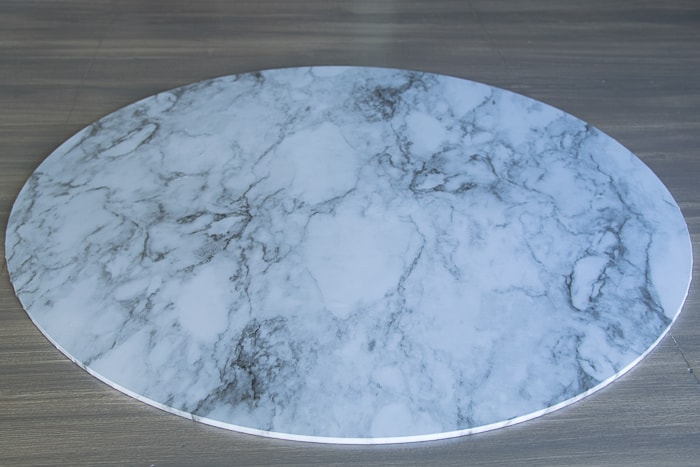 picture showing glass round completely covered in marble shelf liner paper