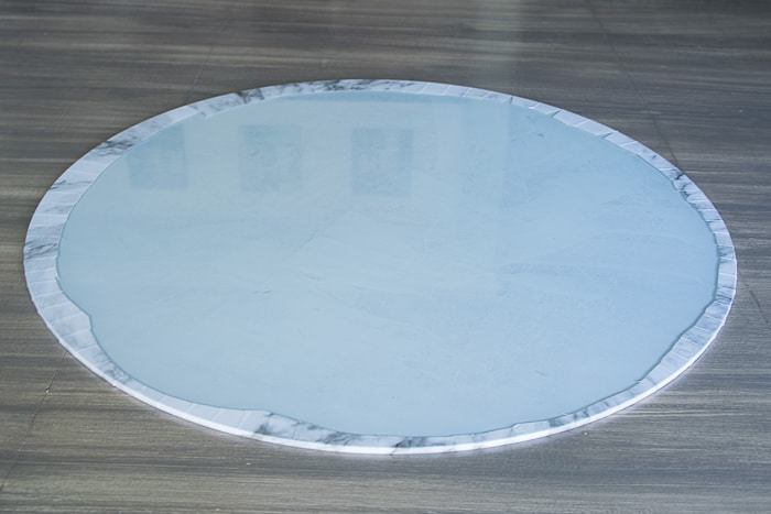 picture showing underside of glass round with marble shelf liner adhered