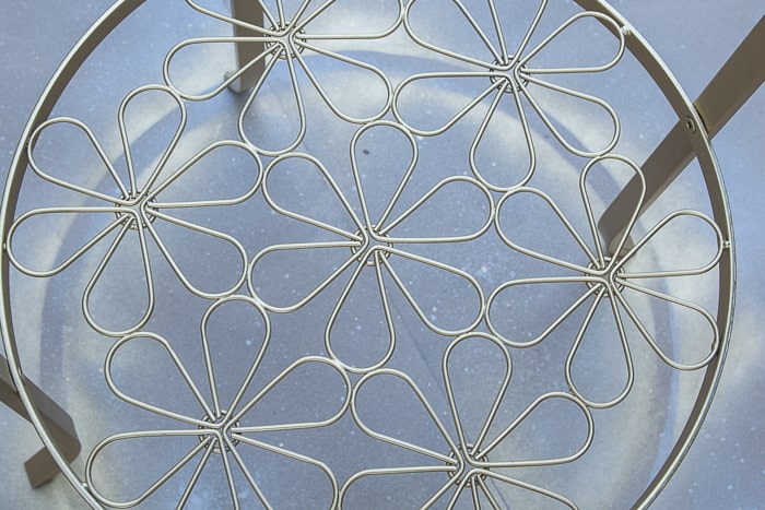 picture of spray painted floral element of round metal Ikea Klingsbo table