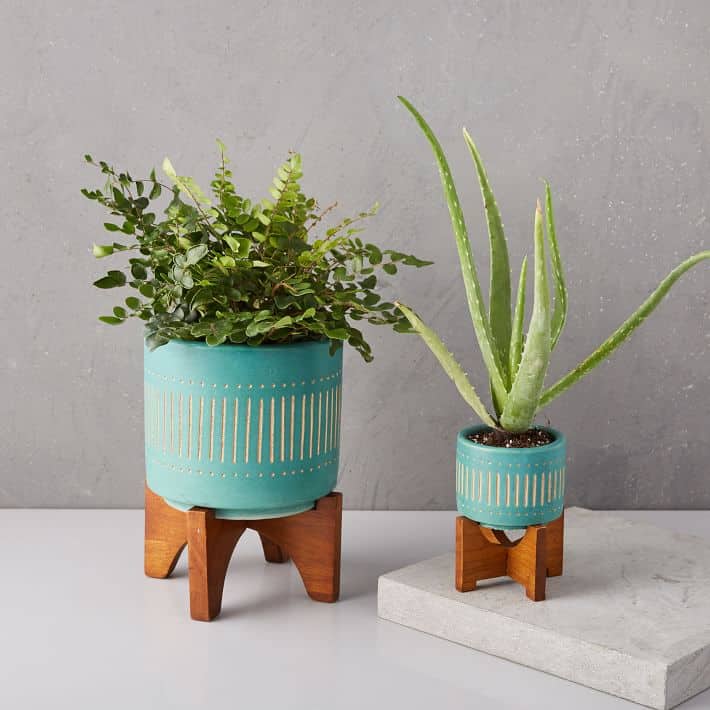 Love the fun turquoise color with the wood legs on these planters!