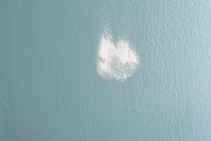example of a hole in the wall patched with spackle