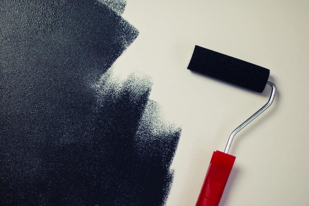 roller with black paint on white background