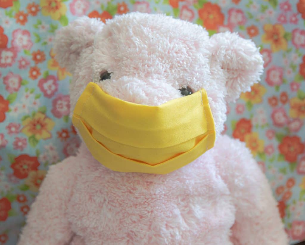 pink bear modeling washable face mask. 