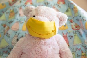 pink bear modeling yellow washable face mask for children