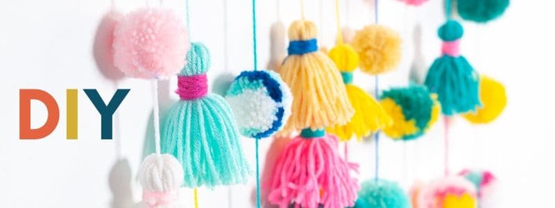 image showing colorful pompoms and multicolor letters spelling DIY