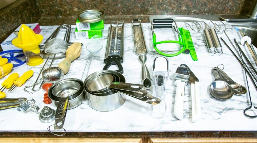 Everything laid out on the counter for organizing kitchen drawers on a dollar store budget