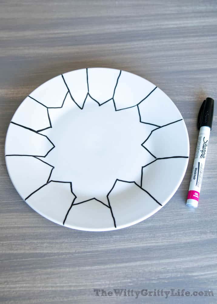 white plate with black outline of houses drawn on