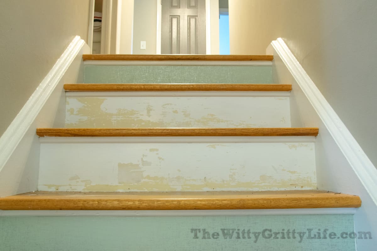 stair risers with wallpaper removed on some of them