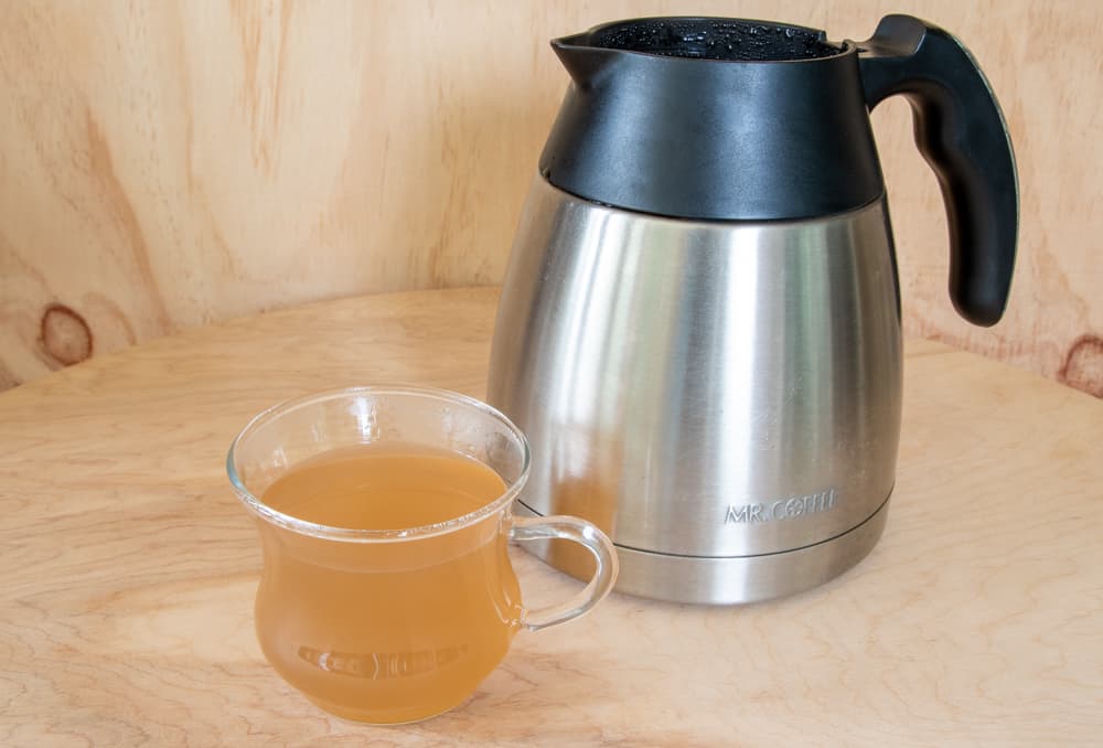 coffee pot and small cup with dirty liquid