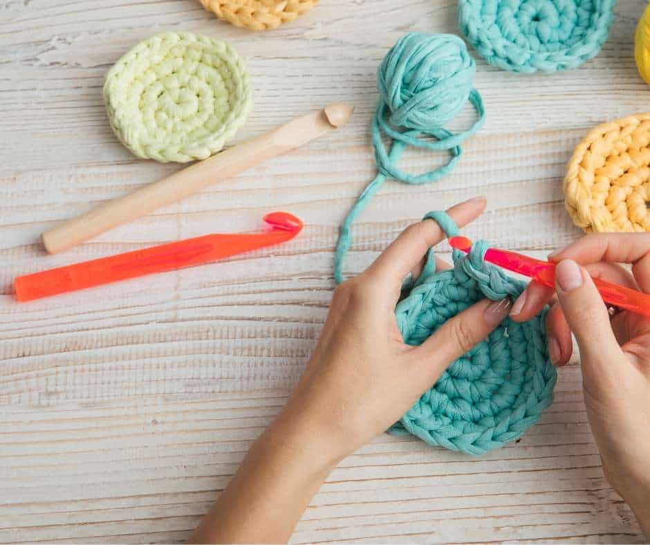 hands with yarn and crochet needles