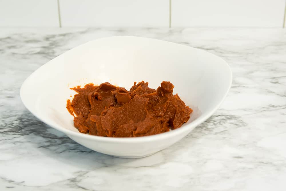 bowl with tomato paste ready to become pizza sauce