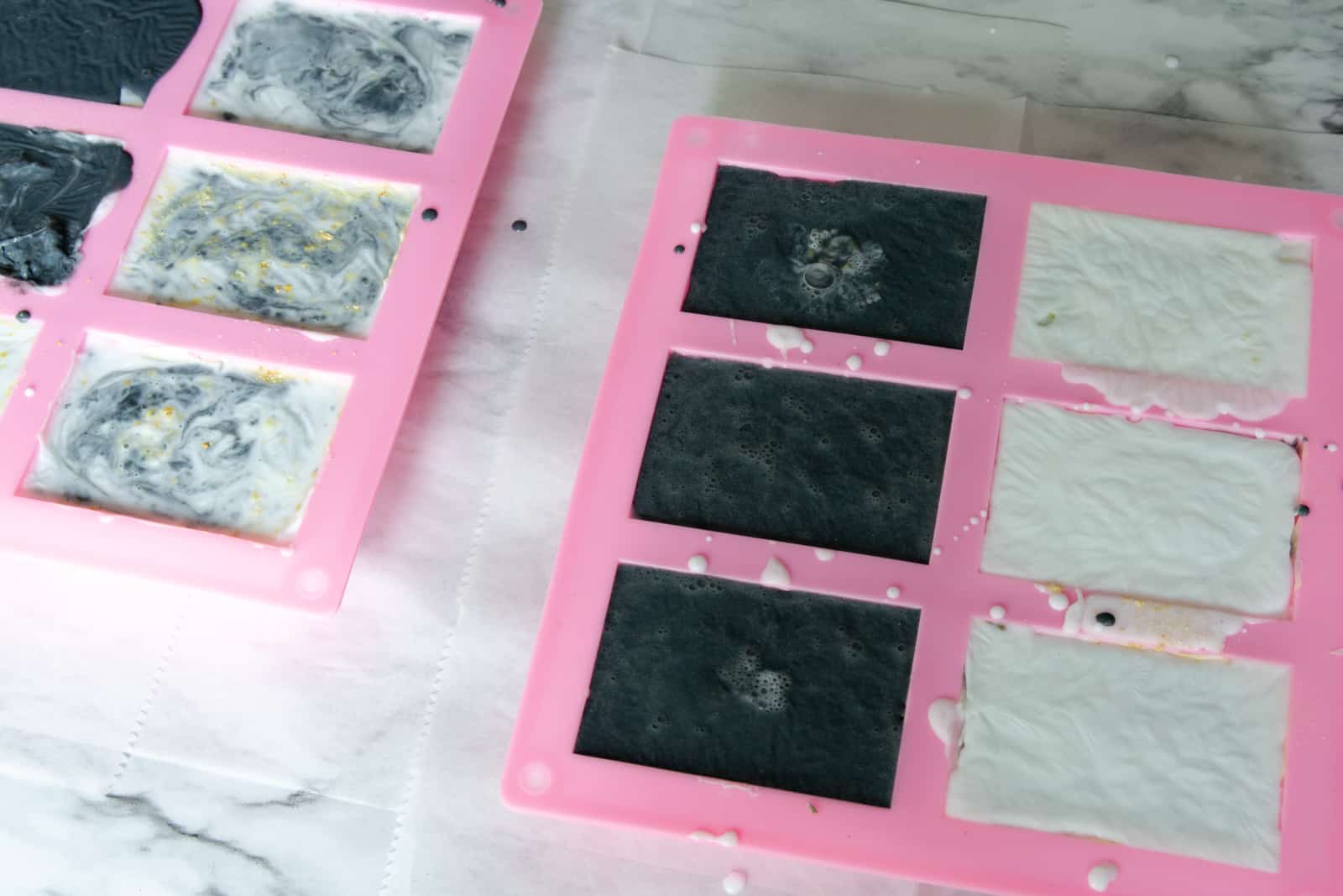 silicone soap molds filled with layered charcoal and white soap