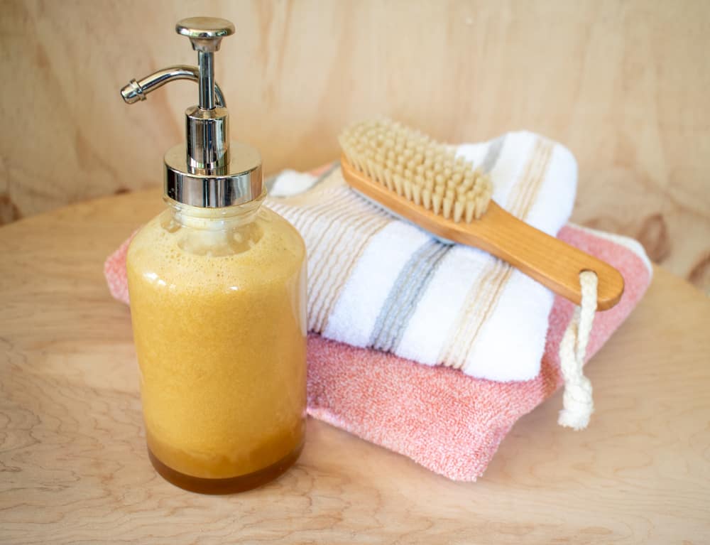 bottle with liquid soap and towels