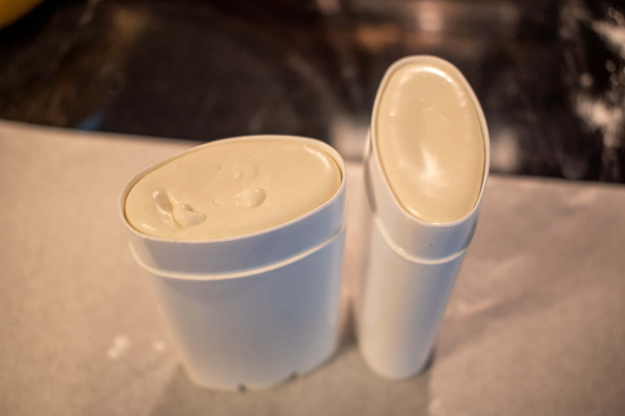 image showing top view of two deodorant containers filled