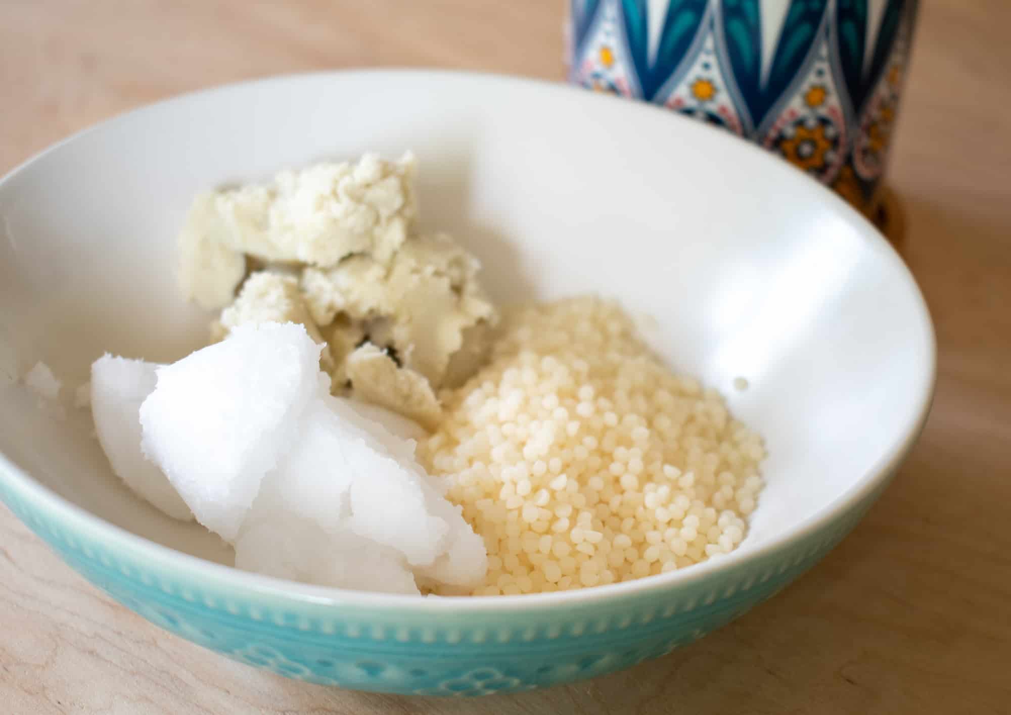 image showing coconut oil shea butter and beeswax pellets in a bowl