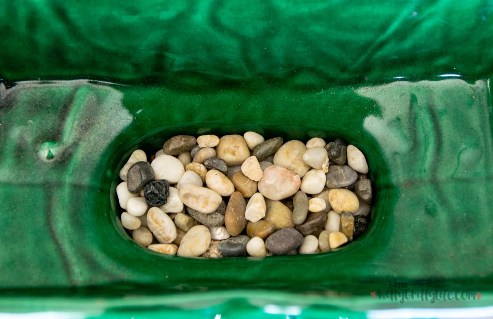 ceramic planter with small pebbles at the bottom for extra drainage