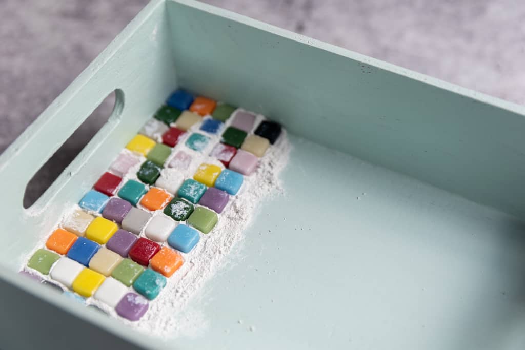 painted wood tray with first few rows of tiles