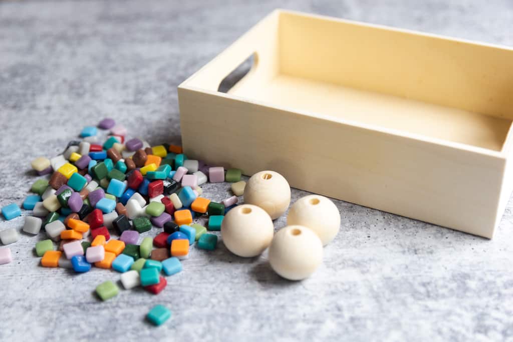 small tiles with large beads and wood tray